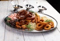 Assorted beer snacks. Sausages, croutons, fried onion rings, shrimps Royalty Free Stock Photo