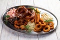 Assorted beer snacks. Sausages, croutons, fried onion rings, shrimps Royalty Free Stock Photo