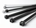 Assorted Black and White Zip Ties with Square Heads on White Background cable tie plastic tie Royalty Free Stock Photo