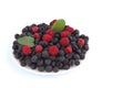 Assorted blackberries and raspberries decorated with mint leaves on a white background Royalty Free Stock Photo