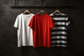 Assorted Blank T-Shirts Hanging Against Dark Wall Royalty Free Stock Photo