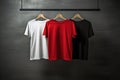 Assorted Blank T-Shirts Hanging Against Dark Wall Royalty Free Stock Photo