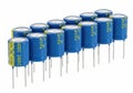 Assorted blue electrolytic capacitors with 25v voltage rating in a row Royalty Free Stock Photo