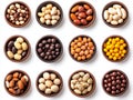 Assorted bowls of colorful nuts and seeds organized symmetrically on a pristine white backdrop, featuring a vibrant showcase of
