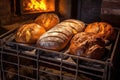 assorted bread loaves cooling on a rack by stone oven