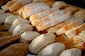 Assorted Bread Rolls and Sliced Loaf in Rustic Bakery Display Royalty Free Stock Photo