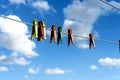 Assorted Bright Plastic Clothes Pegs on a Washing Line