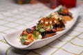 assorted bruschetta with different flavors on a white plate on the table Royalty Free Stock Photo