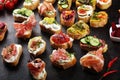 Assorted bruschetta with various toppings. Appetizing bruschetta or brie crostini. Variety of small sandwiches. Mix bruschetta on Royalty Free Stock Photo