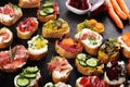 Assorted bruschetta with various toppings. Appetizing bruschetta or brie crostini. Variety of small sandwiches. Mix bruschetta on Royalty Free Stock Photo