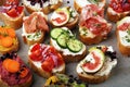 Assorted bruschetta with various toppings. Appetizing bruschetta or brie crostini. Variety of small sandwiches. Mix bruschetta on Royalty Free Stock Photo