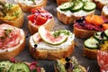 Assorted bruschetta with various toppings. Appetizing bruschetta or brie crostini. Variety of small sandwiches. Mix bruschetta on Royalty Free Stock Photo
