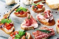 Assorted bruschetta with various toppings. Appetizing bruschetta or crudo crostini. Variety of small sandwiches. Mix bruschetta on Royalty Free Stock Photo