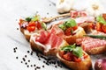 Assorted bruschetta with various toppings. Appetizing bruschetta or crudo crostini. Variety of small sandwiches. Mix bruschetta on Royalty Free Stock Photo