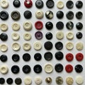 Assorted buttons arranged in a grid pattern on a white background. The collection Royalty Free Stock Photo