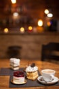 Assorted cakes for dessert over a wooden table in a coffee shop Royalty Free Stock Photo