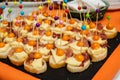Assorted canapes on table closeup. Selection of tasty bruschetta on toasted baguette with prosciuto cheese tomato Royalty Free Stock Photo