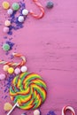 Assorted candy and lollipop on pink wood table. Royalty Free Stock Photo