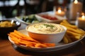 Assorted carrot, cucumber, and bell pepper sticks served with a delicious creamy hummus dip