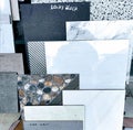 Assorted ceramic and granite floor tile samples on display in a building material store. Royalty Free Stock Photo