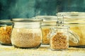 Assorted cereals and grains in glass jars for storage, selective Royalty Free Stock Photo