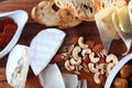 Assorted cheese with nuts. Macro photo. Dried tomatoes in a white dish Royalty Free Stock Photo