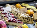 Assorted cheesecake and fruit pastry display in a bakery Royalty Free Stock Photo