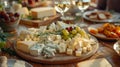 Assorted cheeses and grapes on wooden board for gourmet tasting Royalty Free Stock Photo