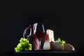 Assorted cheeses and homemade red wine. Hard and soft cheeses. Homemade wine in a ceramic jug. Freespace . Photo on