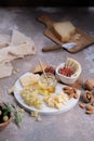 Assorted cheeses on marble board with figs, nuts, grapes and honey Royalty Free Stock Photo