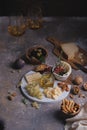 Assorted cheeses on marble plate with figs, nuts, grapes and honey Royalty Free Stock Photo