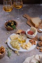 Assorted cheeses on marble plate with figs, nuts, grapes and honey Royalty Free Stock Photo