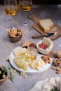Assorted cheeses on marble plate with figs, nuts, grapes and honey Royalty Free Stock Photo