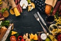 Assorted cheeses, sausages, wines, traditional spices and fresh vegetables on a wooden background. Cheese brie, blue cheese, Royalty Free Stock Photo