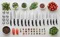 Assorted chef's knives arranged with fresh herbs, spices, and vegetables on white background. Complete set of Royalty Free Stock Photo