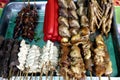 Assorted chicken and pork innards and hotdog in barbecue sticks sold as street food in the Philippines