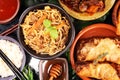Assorted Chinese food set. Chinese noodles, fried rice, peking duck, dim sum, spring rolls. Famous Chinese cuisine dishes on table Royalty Free Stock Photo