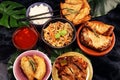 Assorted Chinese food set. Chinese noodles, fried rice, peking duck, dim sum, spring rolls. Famous Chinese cuisine dishes on table Royalty Free Stock Photo