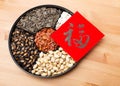 Assorted chinese sytle snack tray and chinese calligraphy, meaning for blessing good luck Royalty Free Stock Photo
