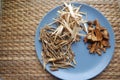 Assorted chinese traditional medicine herbs on a plate.