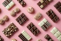 Assorted chocolate candies on pink background, top view. Chocolate pralines flat lay. Handmade chocolate candy sweets