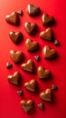Assorted Chocolate Hearts on a Vibrant Red Background Perfect for Valentine\'s Day Celebrations and Romantic Occasions