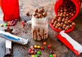 Assorted chocolate Milkshake with ice cream, colorful bunty candy and whipped cream served in jar isolated on dark background side Royalty Free Stock Photo