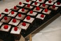 Assorted chocolate squares paired with fresh raspberries beautifully arranged on a tabletop