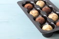 assorted chocolates. candy balls of different types of chocolate on a blue wooden table. free space. close-up Royalty Free Stock Photo