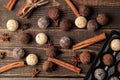 assorted chocolates. candy balls of different types of chocolate on a brown wooden table. cinnamon and almonds. top view Royalty Free Stock Photo