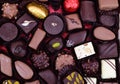 Assorted chocolates laid out on red corrugated paper Royalty Free Stock Photo