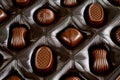 Assorted chocolates lying in a box. Background for products from chocolate and sweets. Dark chocolate