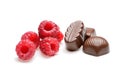 Assorted chocolates with raspberries on the white background Royalty Free Stock Photo