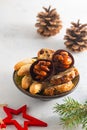 Assorted Christmas cookies and sweets on a round plate on a light concrete background in Christmas style. Merry Christmas concept